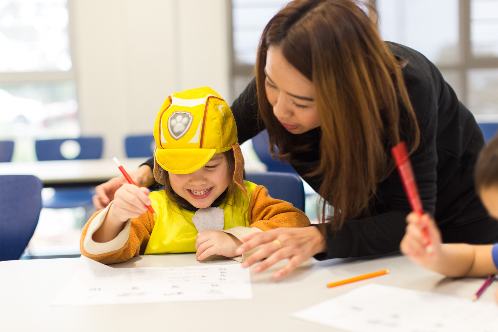 Thai language and culture teacher in class with child student learning and teaching Thai in Melbourne Victoria. 